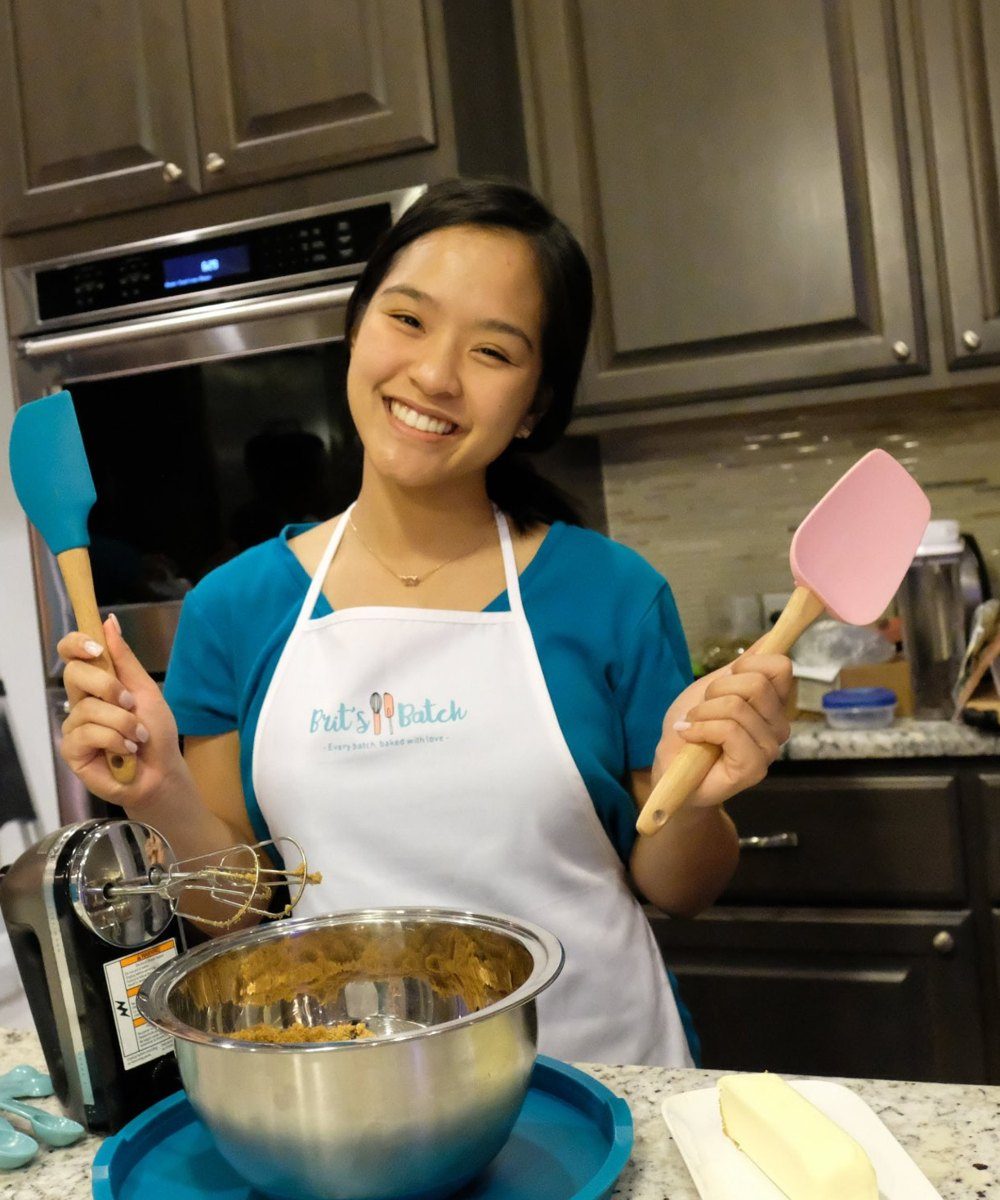 Britney in a Brit’s Batch apron, baking cookies at home