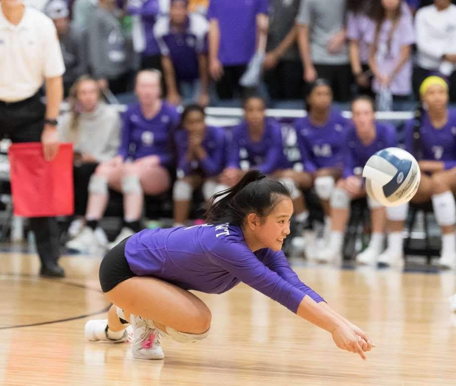 Britney diving for a dig during a volleyball match
